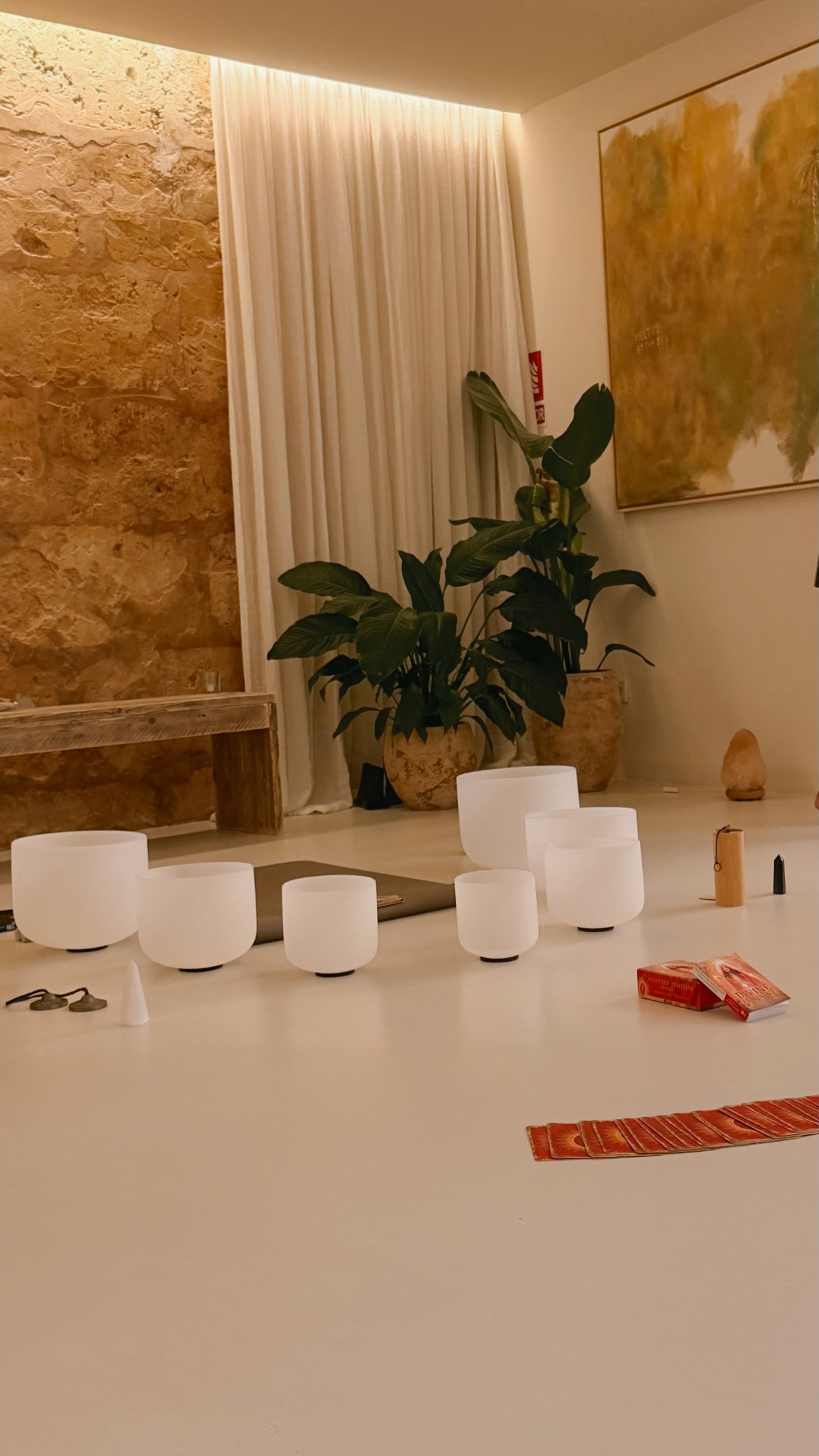 Crystal singing bowls for a sound healing in a warmly lit room