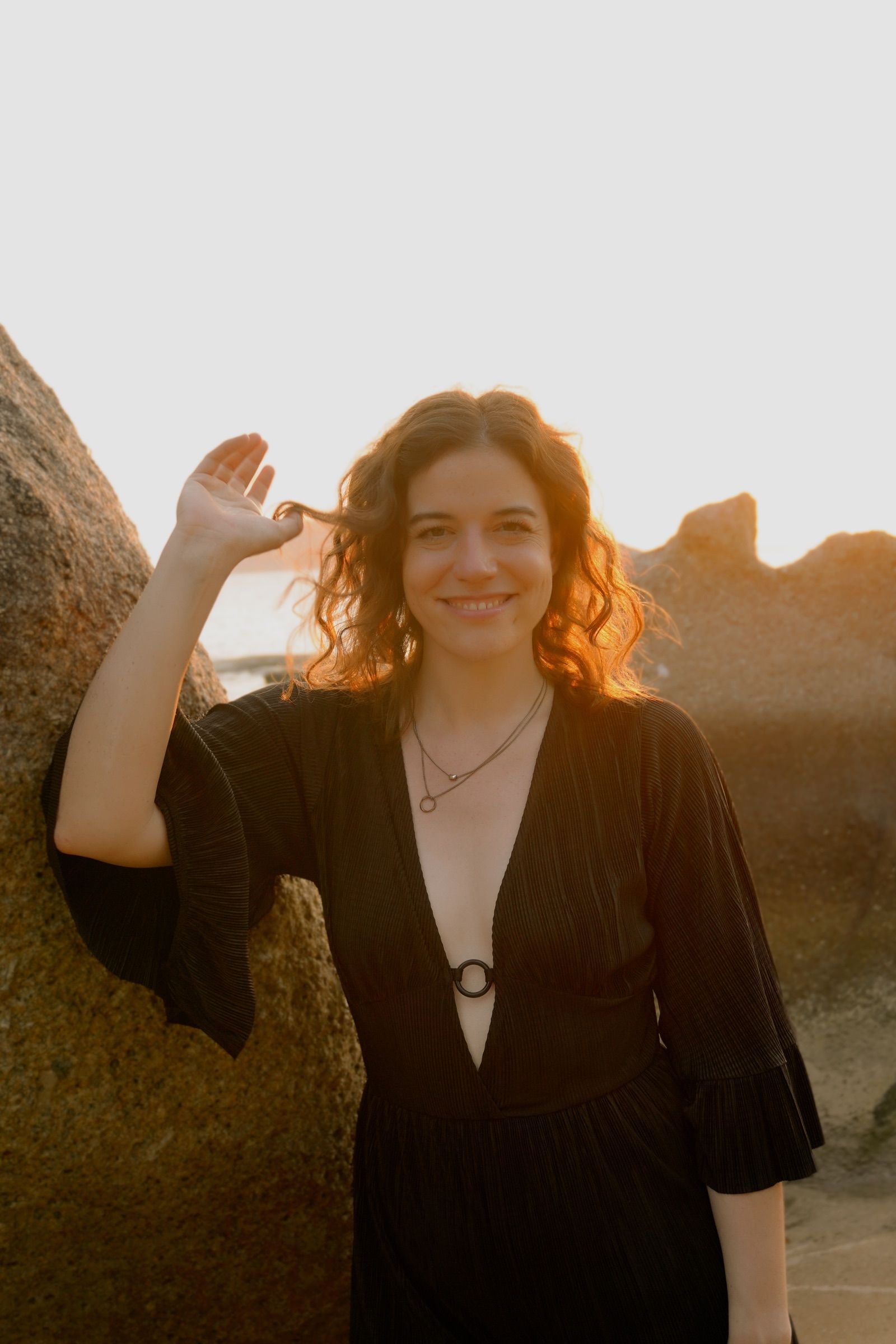 Lena Lambrecht in golden evening light by a rock
