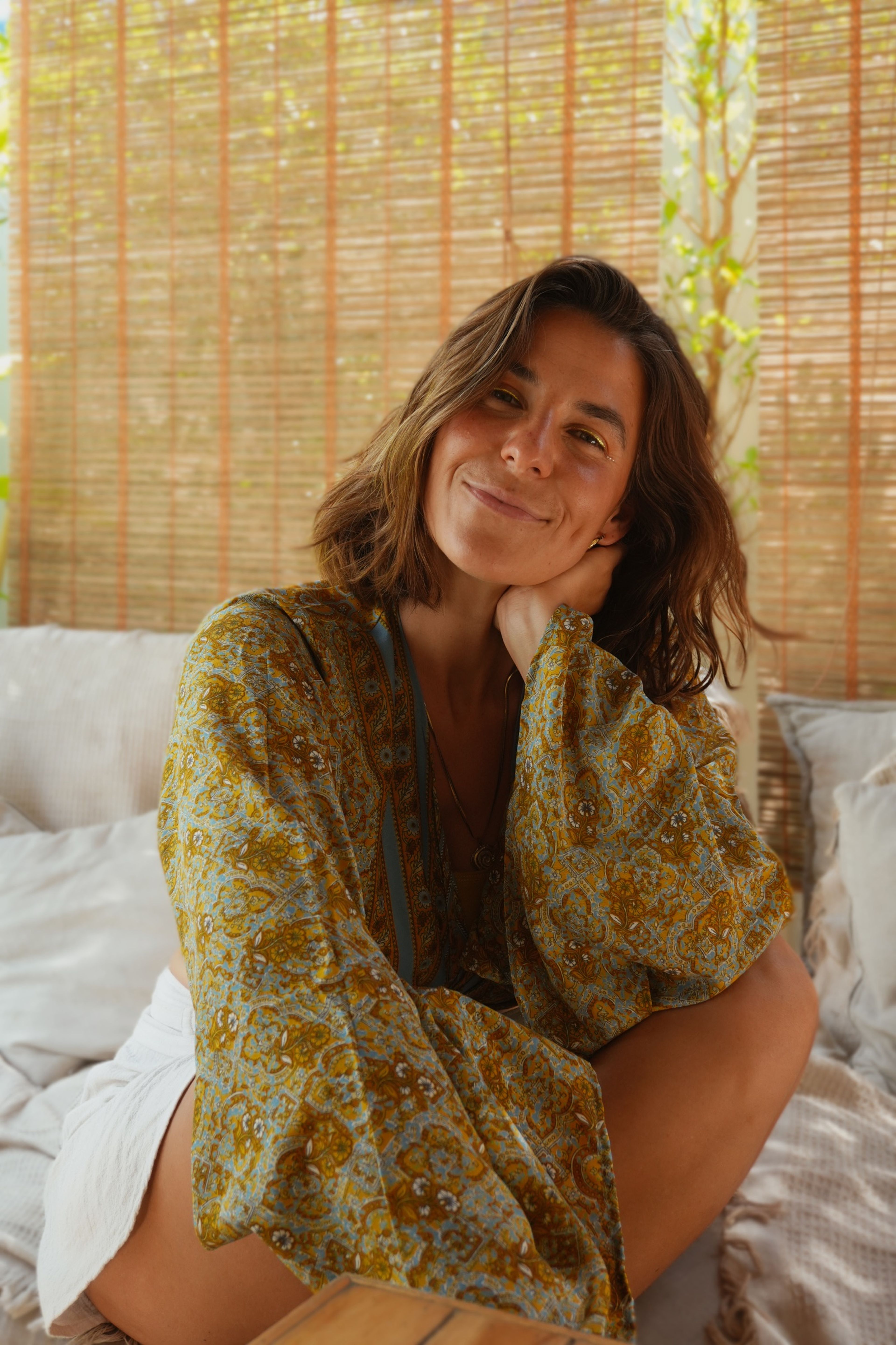 Judith Krüger smiling in a patterned kimono in front of a bamboo wall