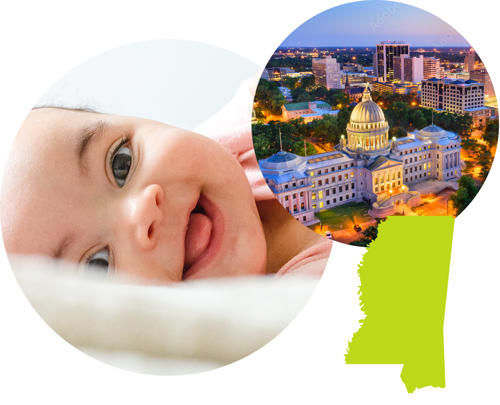 Baby smiling next to an aerial photo of the State Capitol Building in Jackson, Mississippi.