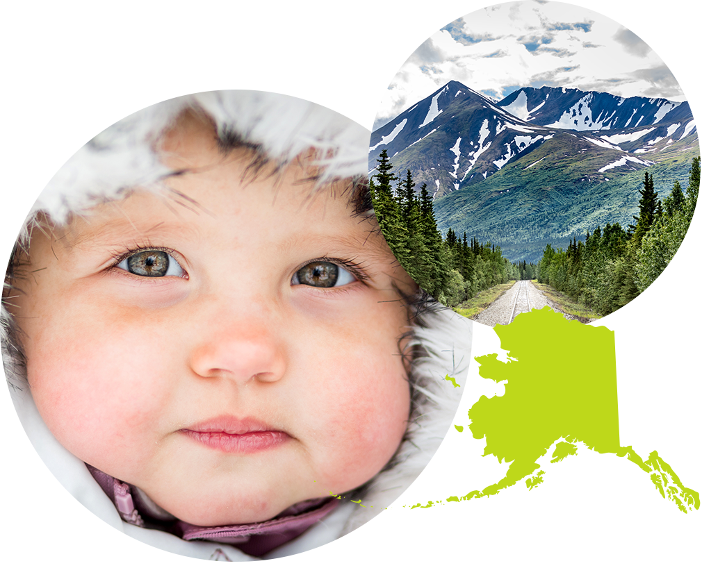 Baby boy in a parka next to photo of a highway and snowy mountains in Alaska.