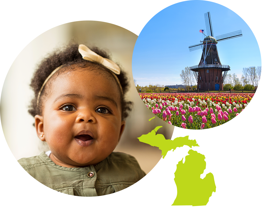 Baby girl with a bow in her hair next to image of a windmill in a field in Michigan.