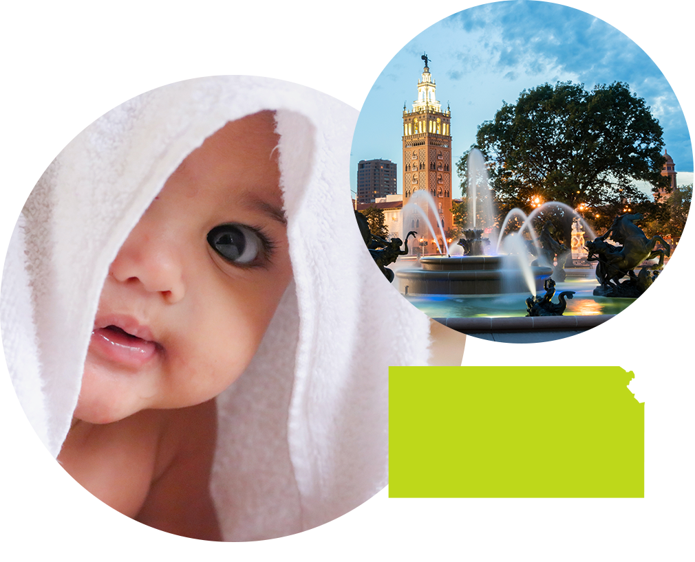 Baby boy covered in a towel next to image of fountain and tower in Kansas.