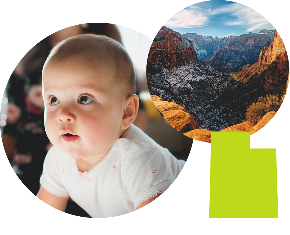 Baby boy with brown eyes next to photo of Zion National Park in Utah.