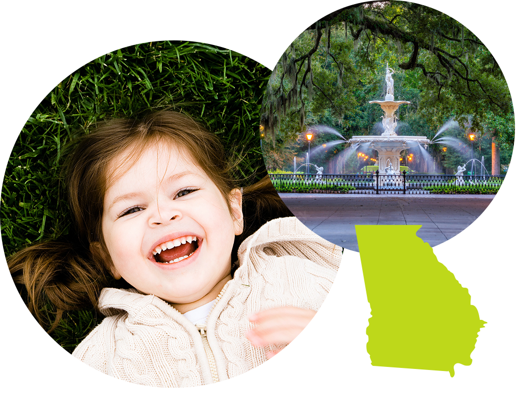 Smiling little girl next to a fountain in a park in Georgia.