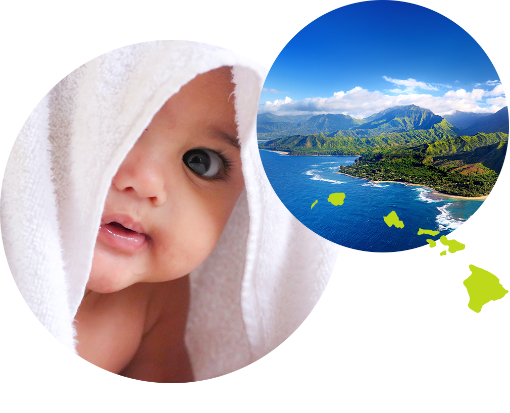Baby boy covered in a towel next to image of an island, ocean, and volcanos in Hawaii.