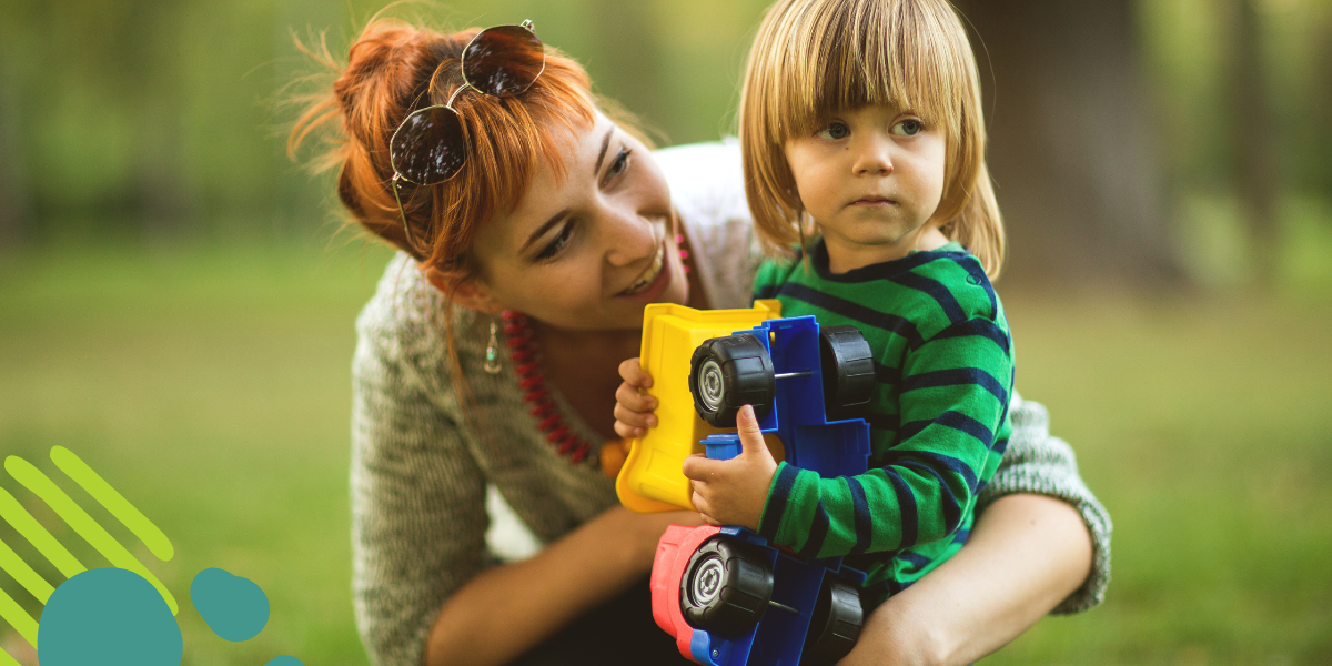 single mom playing outside with her child