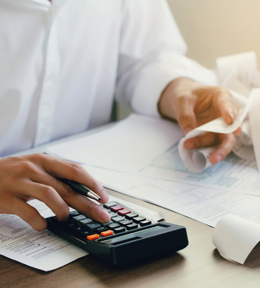 Finance Workspace A Person Using a Calculator