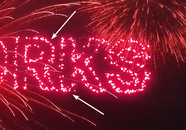 Upclose look of the firework text with arrows pointing at the tiny white dots