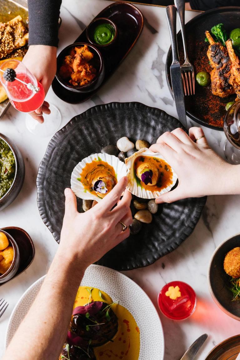 Guests sharing a meal at Farzi London