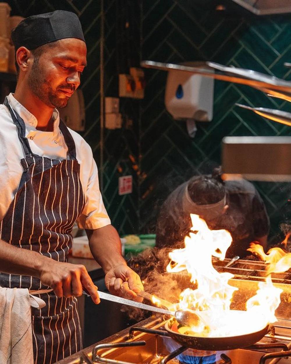 Chef at Farzi London cooking indian food with fire