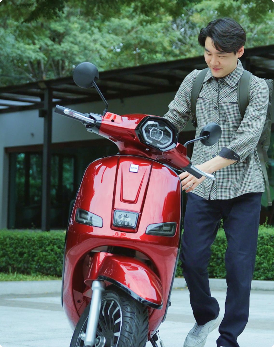 A man man holding Red EM ENZO