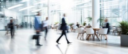 People walking through building lobby