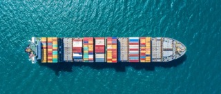 cargo ship travelling between trade ports