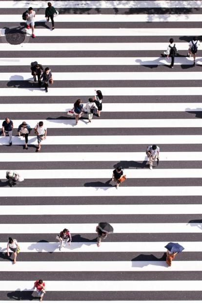 aerial shot of people crossing the road