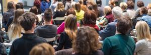 An audience listen to a speaker