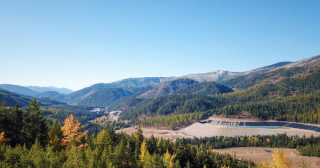 Mine site in the distance surrounded by trees