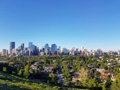 Wide angle shot of Calgary's downtown in the background and a residential neighbourhood in the foreground