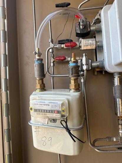 Positive displacement meter installed on a natural gas controller