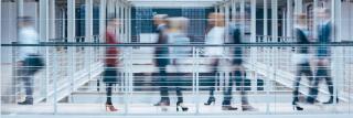 People talking in office corridor, blurry