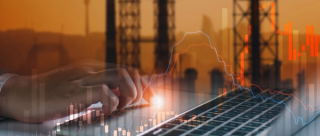 hand typing on a laptop with energy indicators in the background