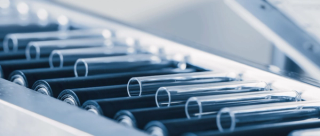 Pharmaceutical test tubes on industrial conveyor belt