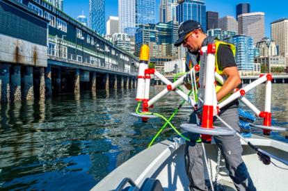 Man on boat holding underwater deployment equipment
