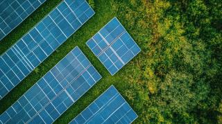 Birdseye view of solar panels in a green field