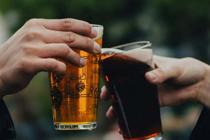 Two pints of beer in a cheers motion
