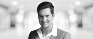 Headshot of Sven Dressler with a blurred office background behind him