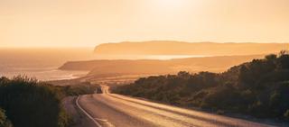 Beautiful winding road across the Innes National Park with car at sunset time