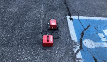 Red vibration measurement boxes in a parking lot