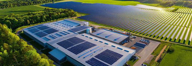 Building with solar panels across from a field of solar panels