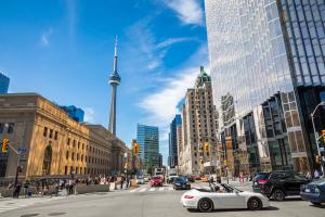 Pedestrians and cars at busy downtown Toronto intersection