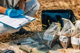 Soil Test. Female Agronomist Taking Notes In The Field