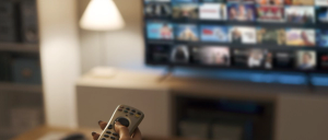 Young woman watching video on demand on her TV