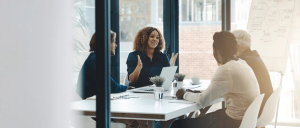 Woman presents at a strategy board meeting