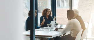 Woman presents at a strategy board meeting