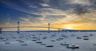 Sunrise over Jamestown Harbor and Newport Bridge in Rhode Island with fishing boats and sailboats