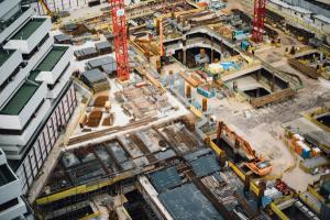 Aerial view of a construction site with cranes and diggers