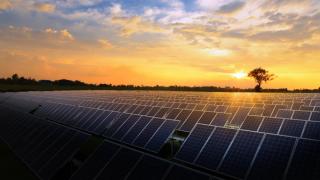 Solar panels set against a sunrise