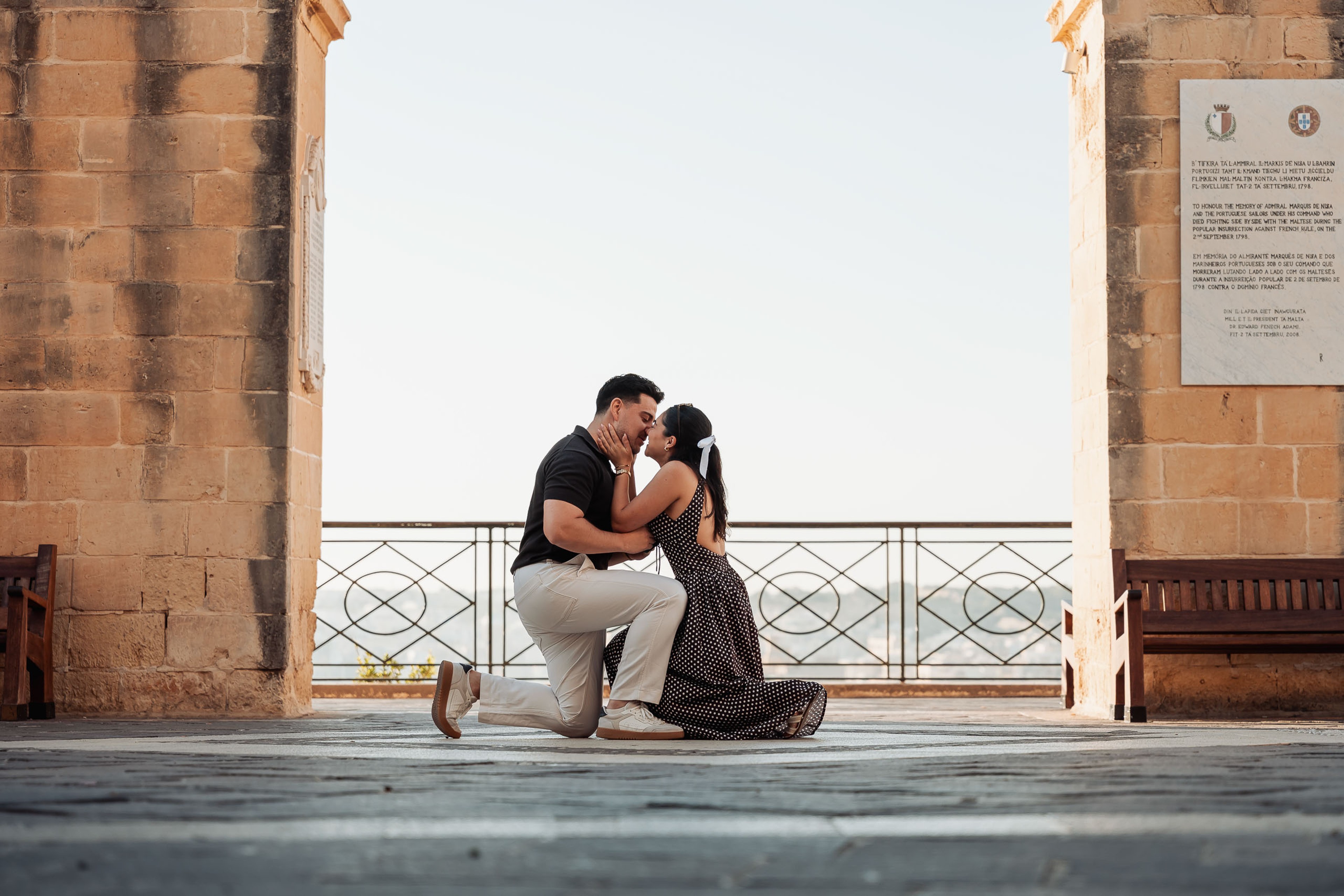 Surprise proposal at Upper Barrakka Gardens in Valletta, Malta, as he gets down on one knee.