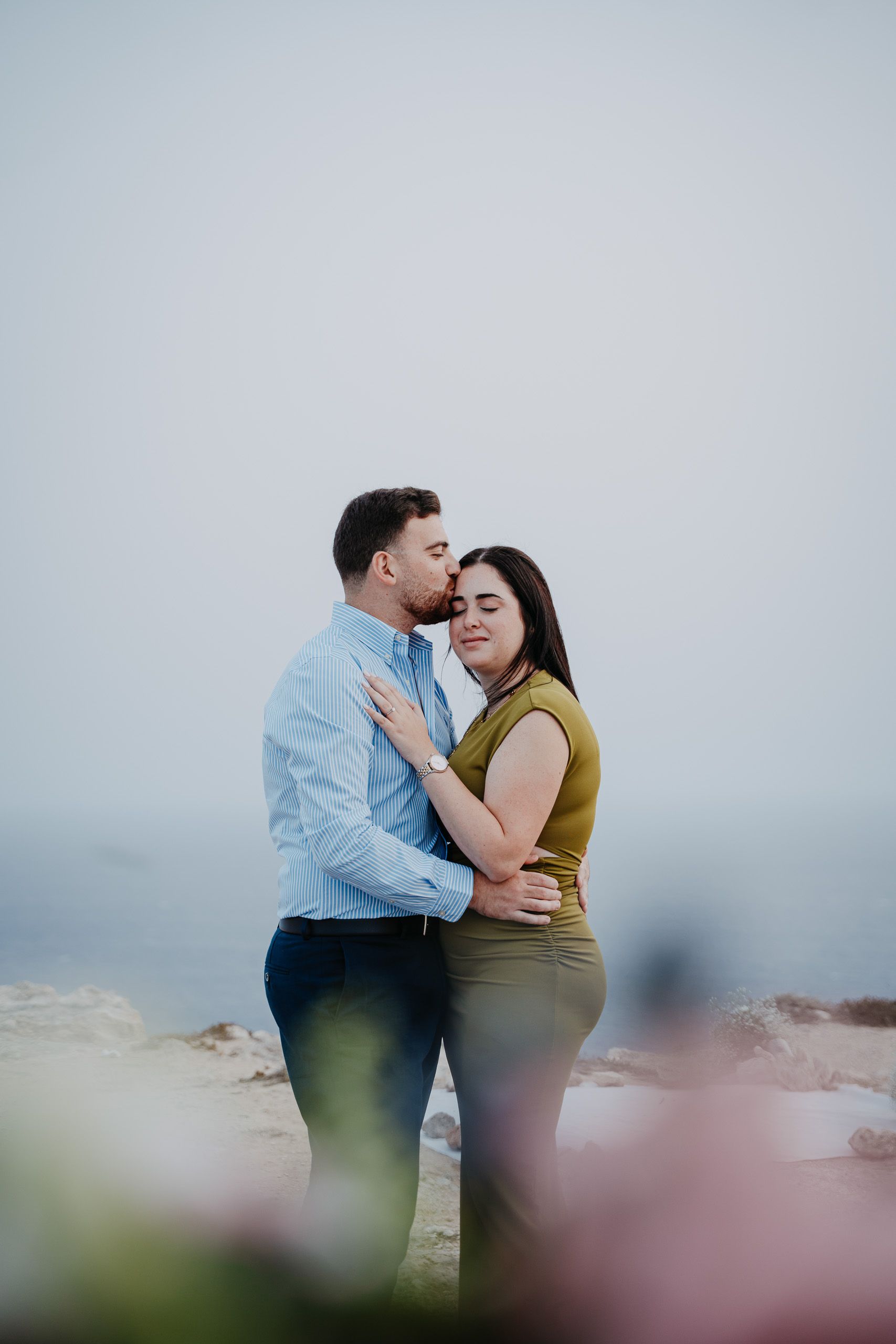 Romantic engaged couple portrait overlooking the sea at Dingli Cliffs, Malta