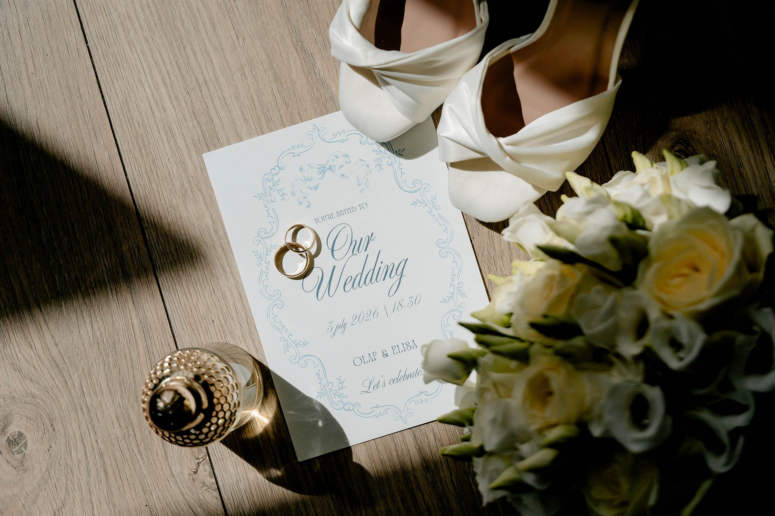 Wedding rings, bridal shoes, bouquet and invitation photographed before the ceremony in Den Helder, Netherlands.