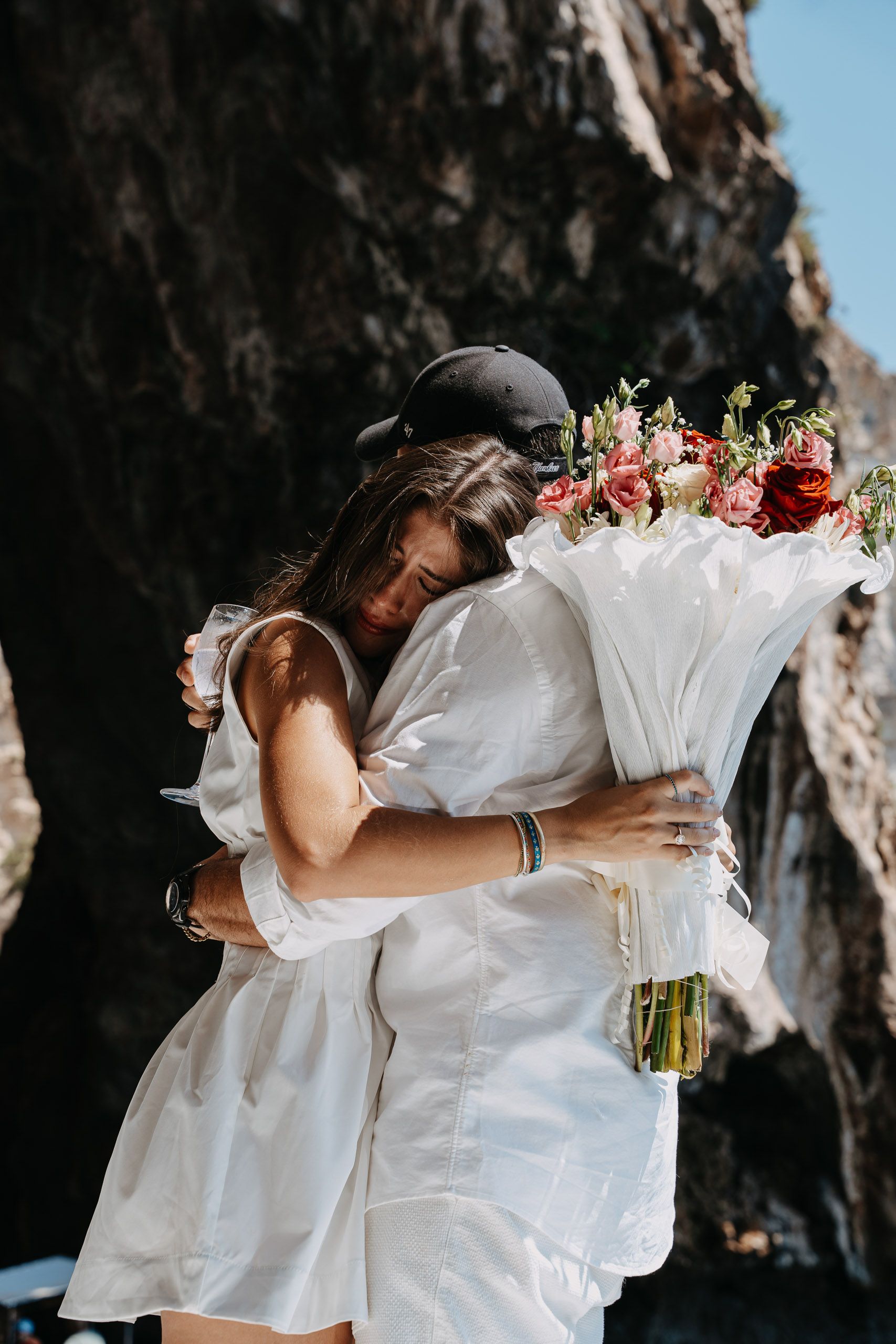 Newly engaged couple hugging after a Blue Grotto boat proposal in Malta