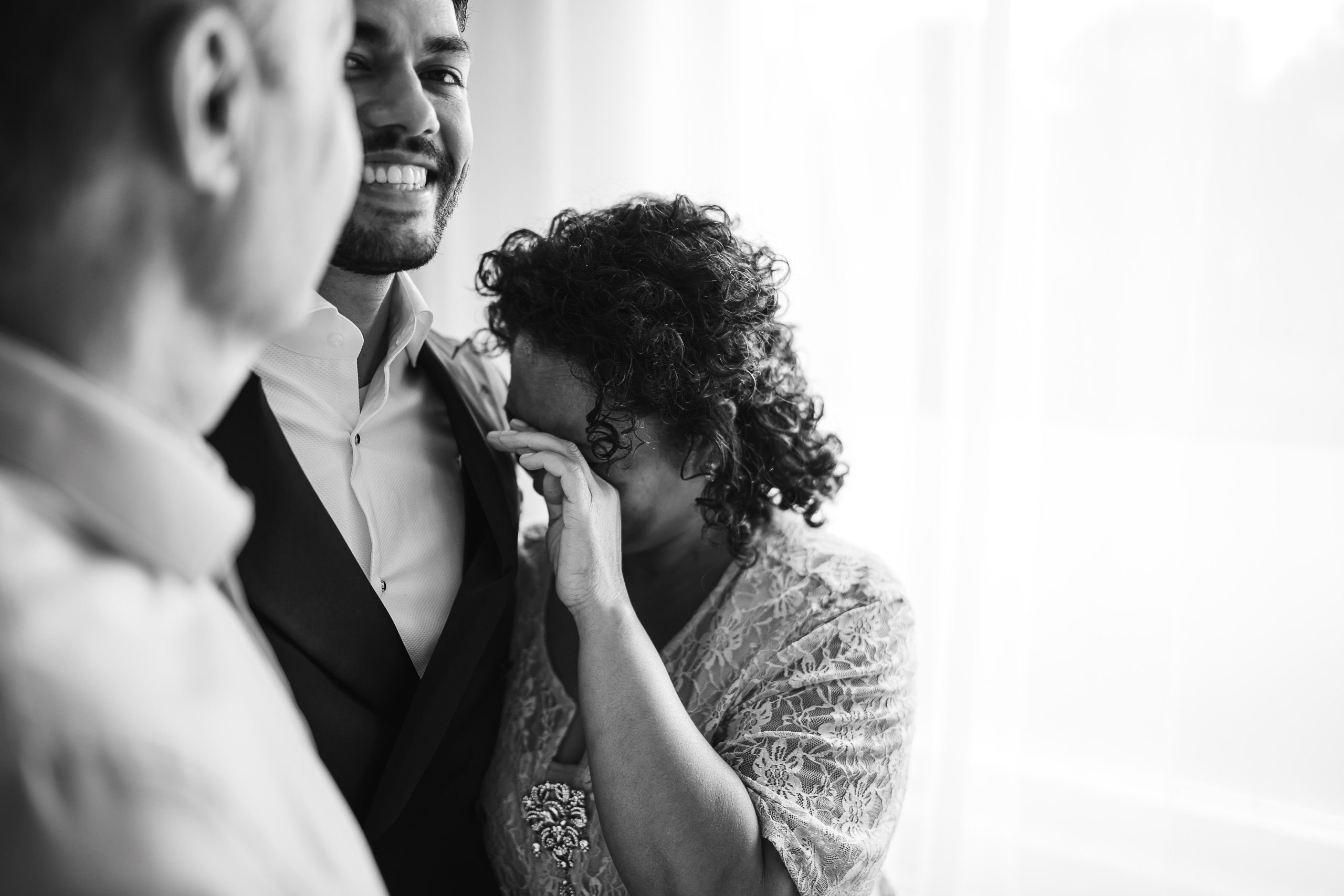 Emotional moment as the groom’s mother helps him get ready for his wedding in Den Helder, Netherlands.