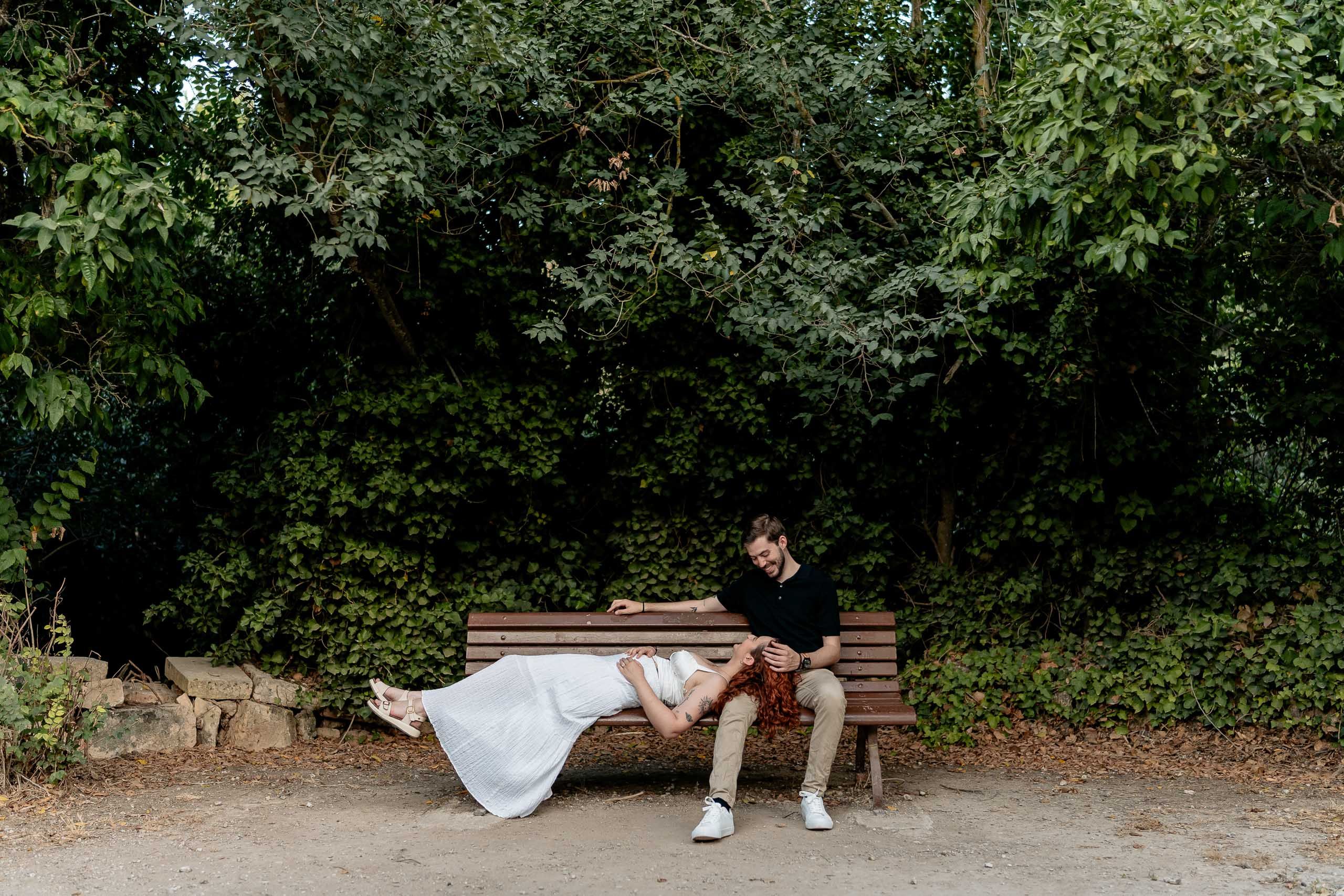 Jay and Cristina relaxing together on a bench during their pre-wedding shoot at Buskett Woodlands in Rabat, Malta.