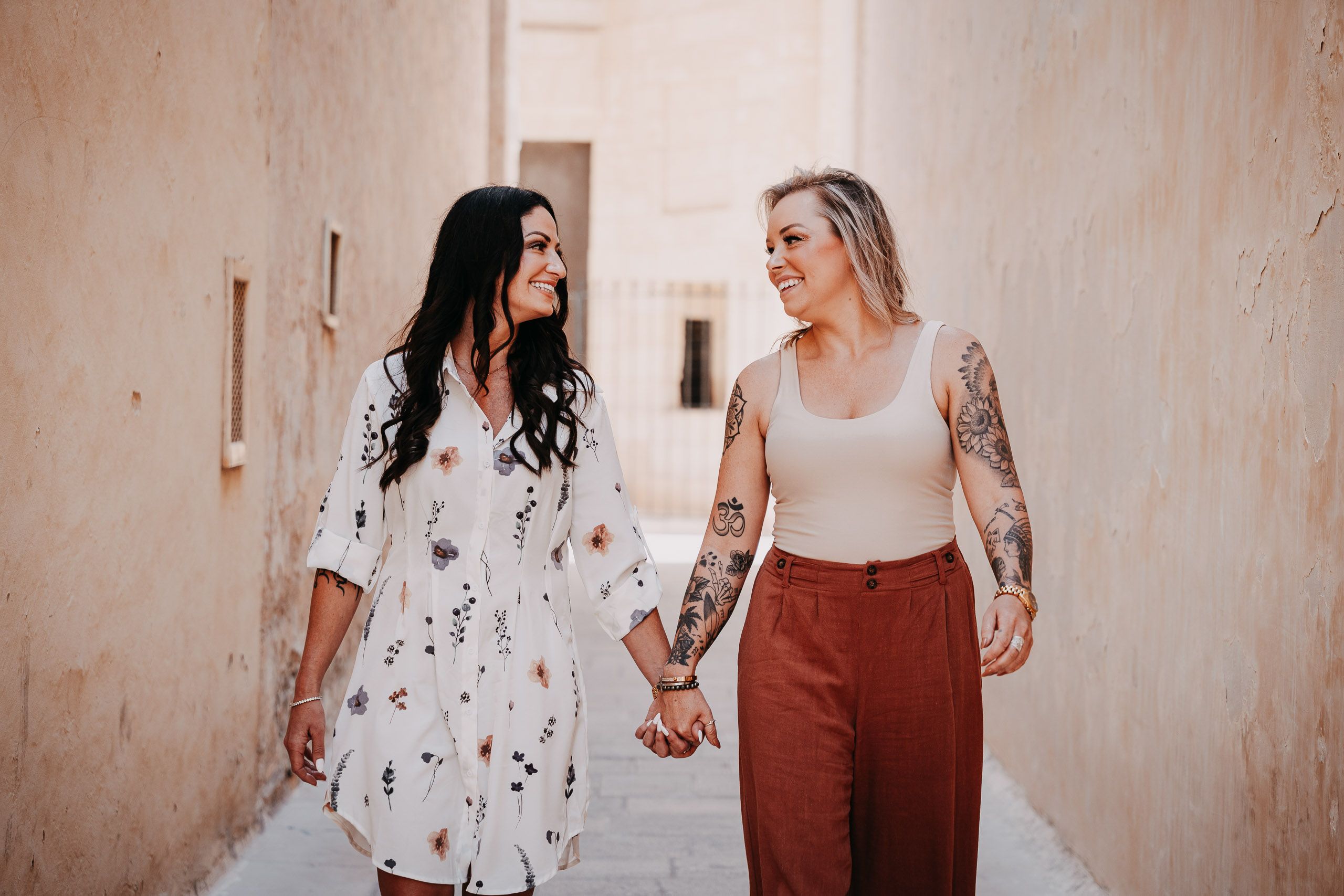 Newly engaged couple walking through the historic streets of Mdina, Malta