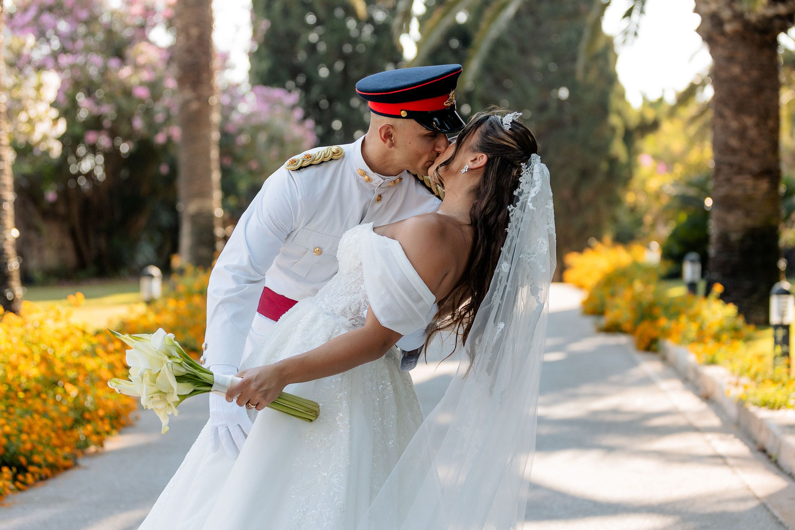 Bride and groom kissing in the gardens at Ir-Razzett L-Abjad during their Malta wedding.