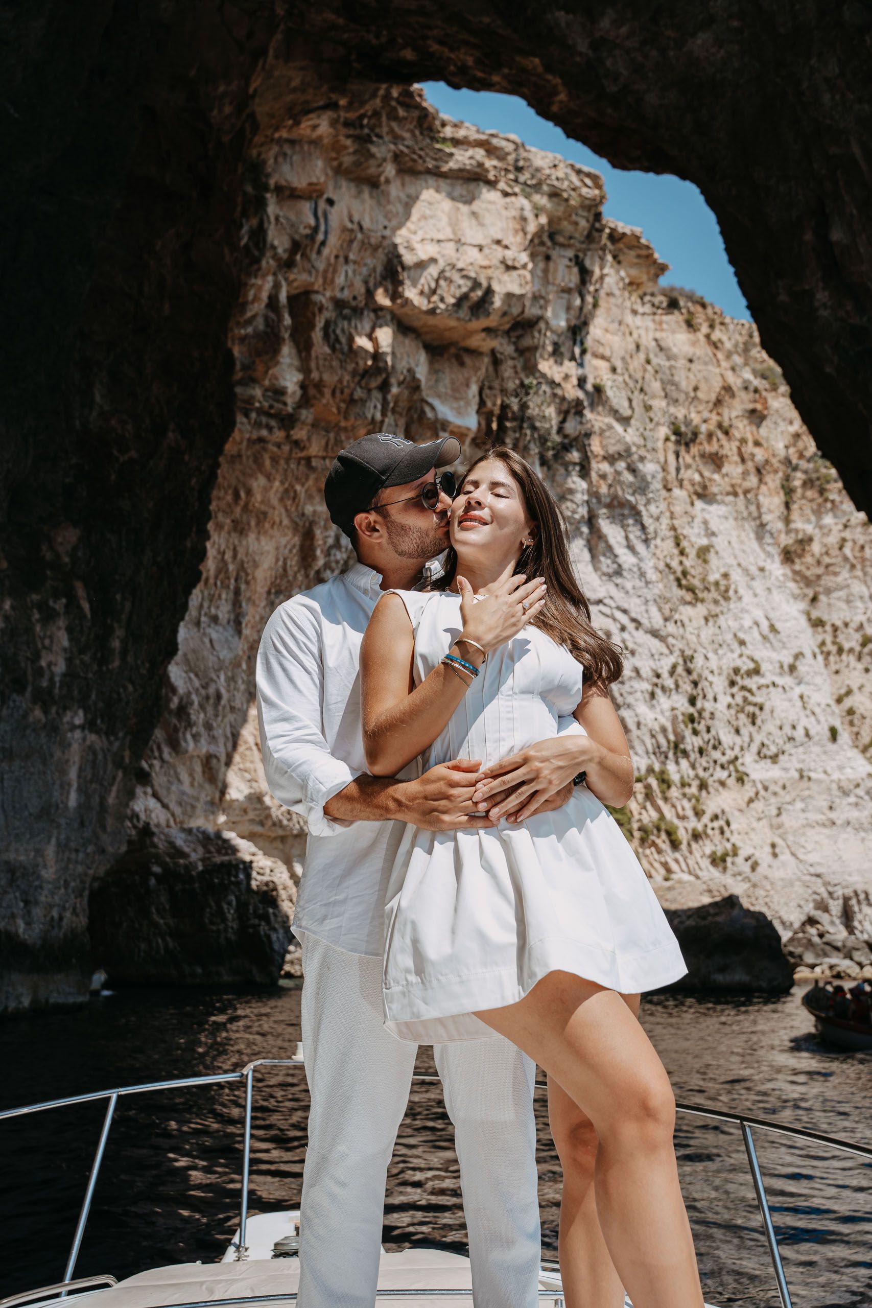 Newly engaged couple celebrating their boat proposal at Blue Grotto, Malta
